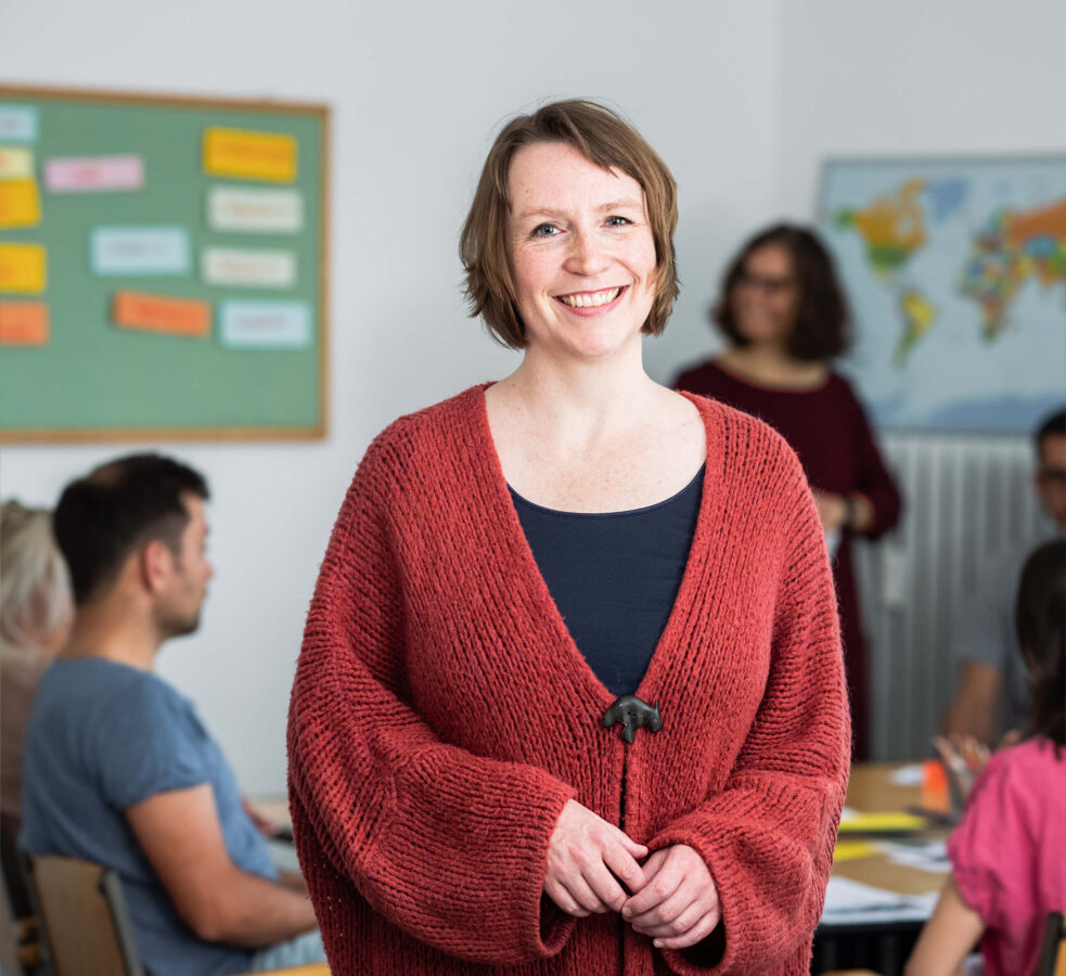 Franziska Becker, director of SprachPassion, in the German language institute Frankfurt; in the background a teacher speaks with a German learner